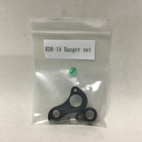 A clear plastic package containing a black bicycle rear hanger set with small metal components, labeled with 'Kanzo Fast Rear Hanger Set NFD HXD'.